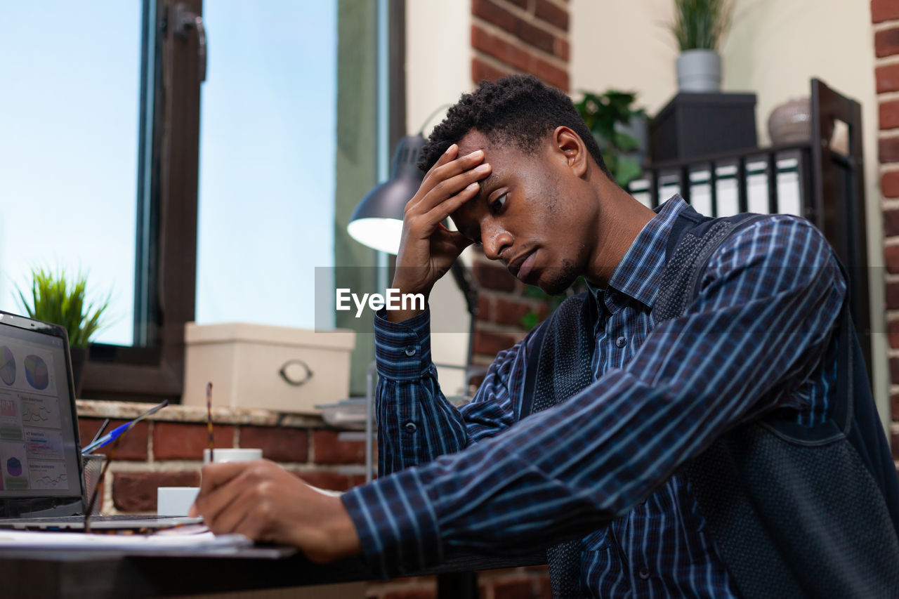 Frustrated businessman sitting at office