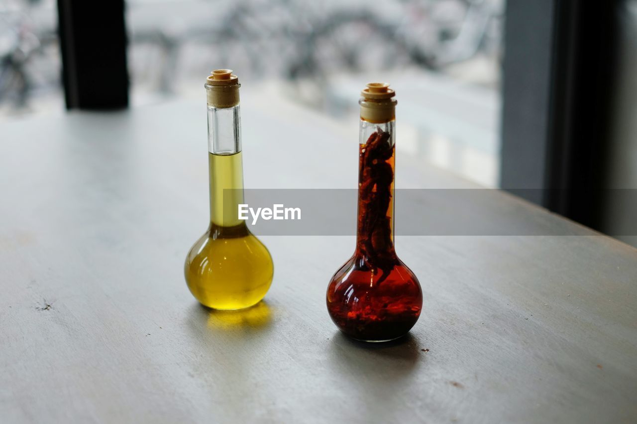 High angle view of aromatherapy oils in bottles on table