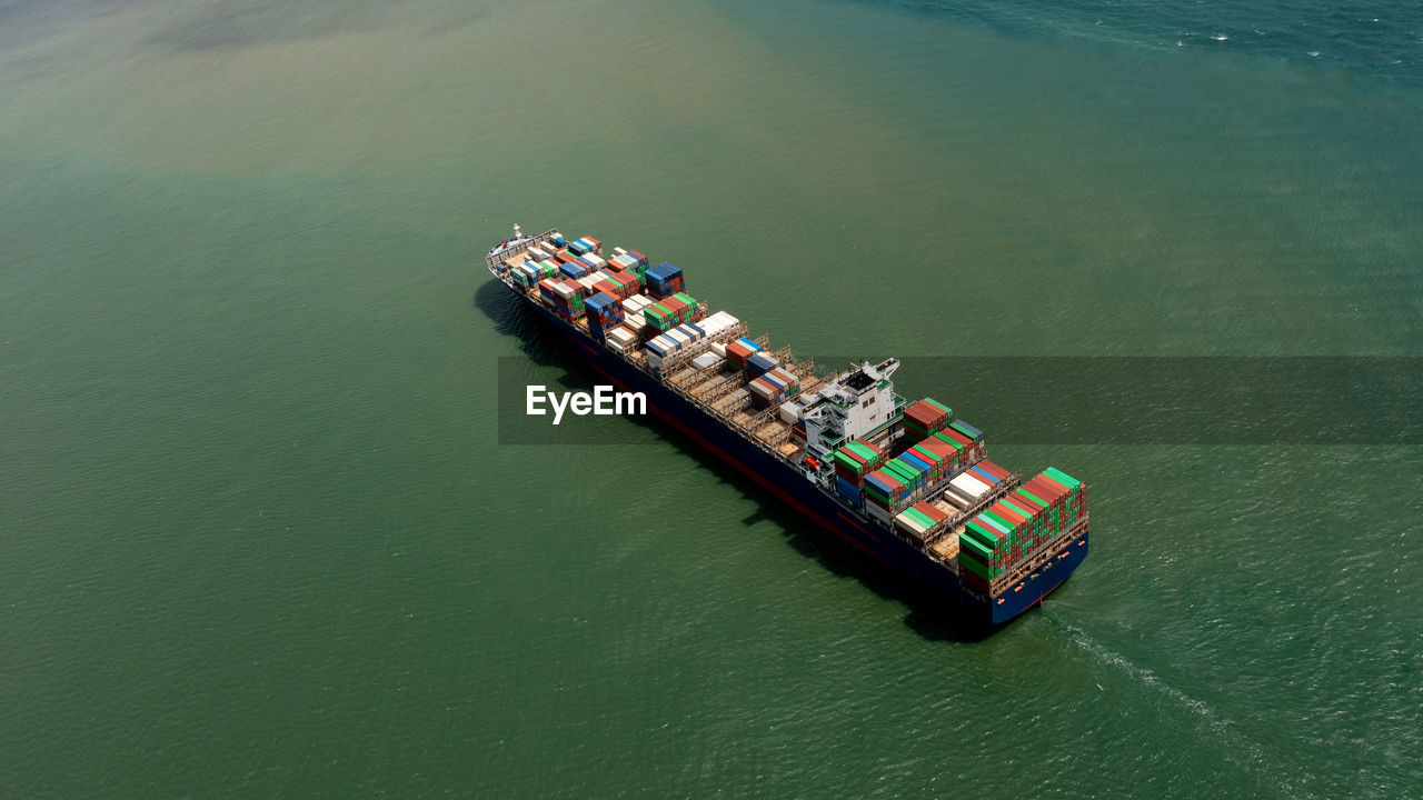 Container ship export and import business services and logistics. shipping cargo to harbor transport 