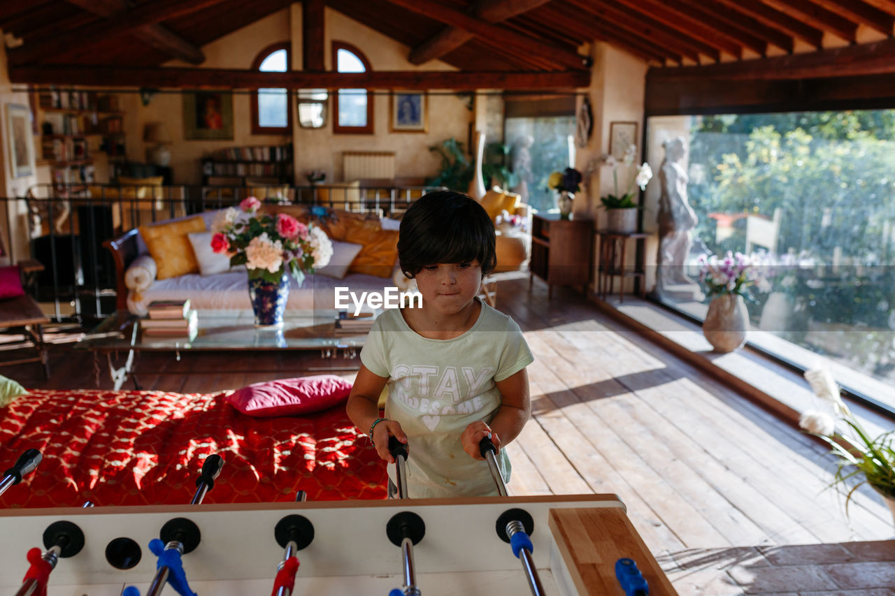 Upper view on girl playing table football