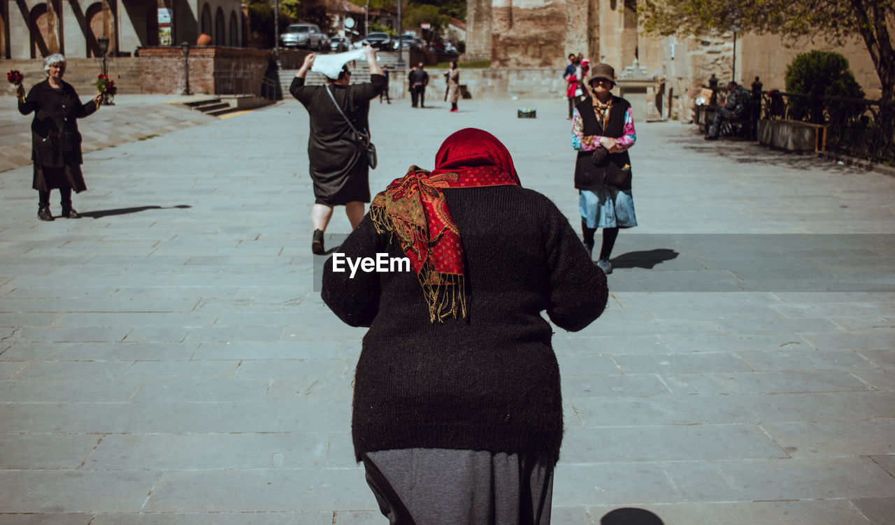 Rear view of woman walking in city