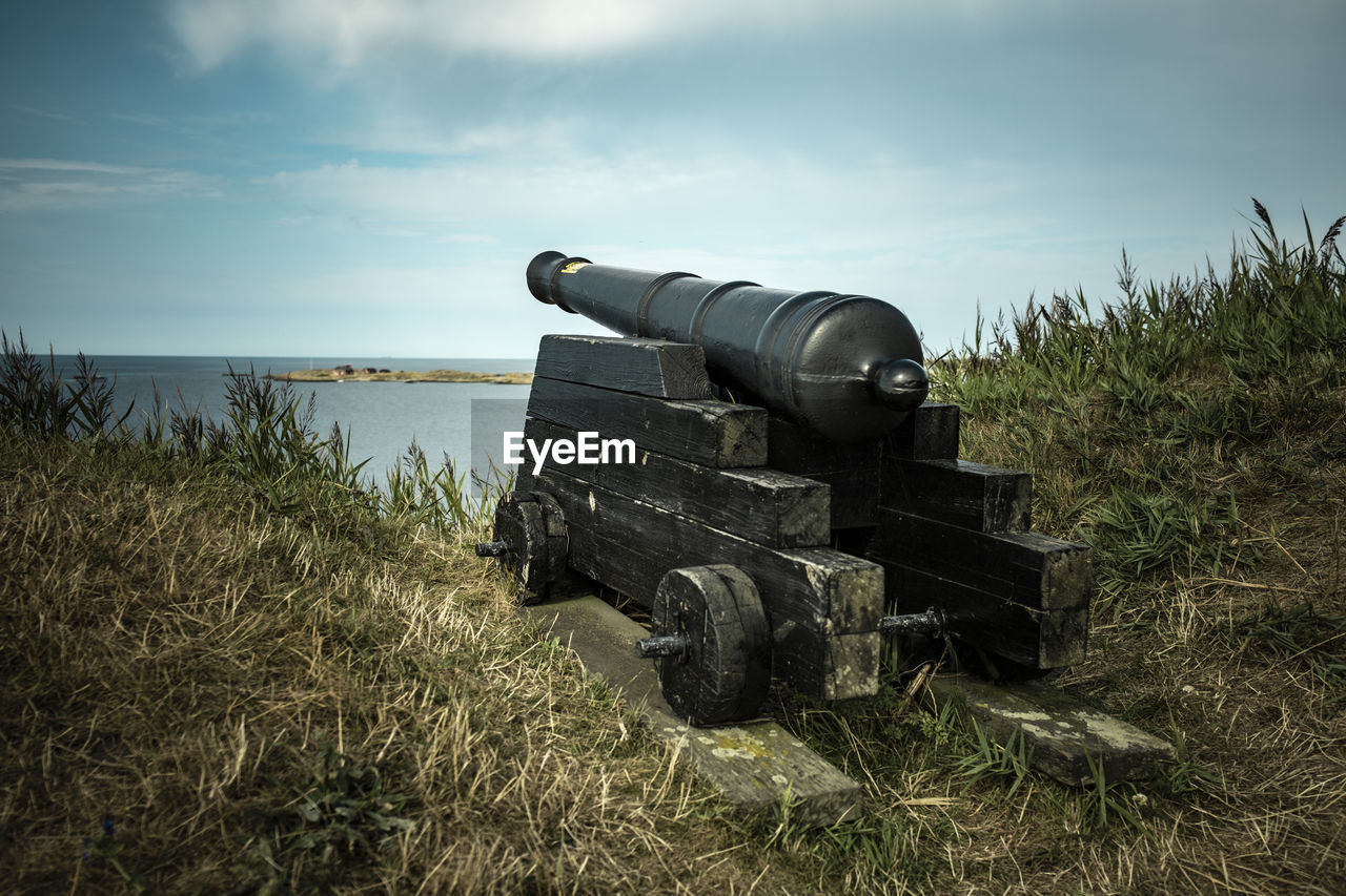 sky, cannon, weapon, nature, war, land, fighting, plant, conflict, history, grass, military, the past, cloud, no people, day, outdoors, water, sea, field, security, landscape, scenics - nature, vehicle