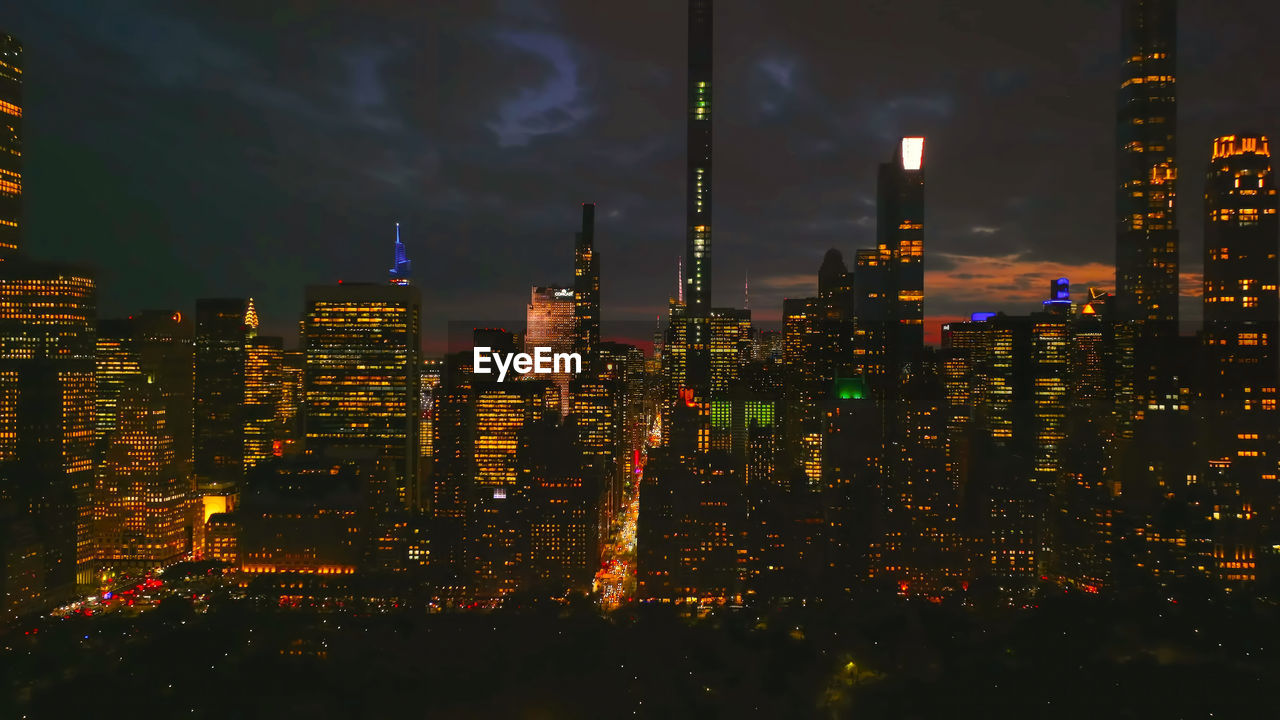 high angle view of illuminated buildings in city at night