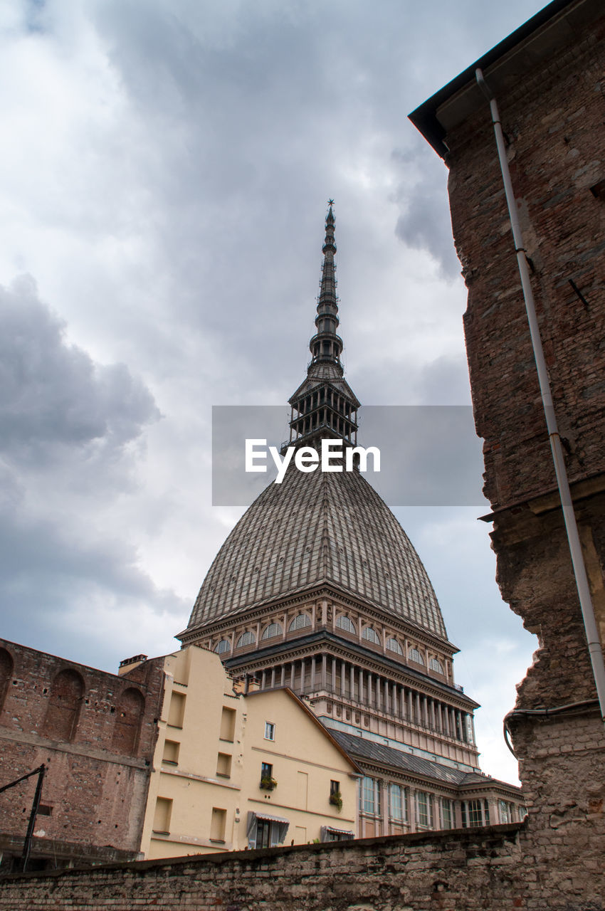 LOW ANGLE VIEW OF TEMPLE AGAINST CLOUDY SKY