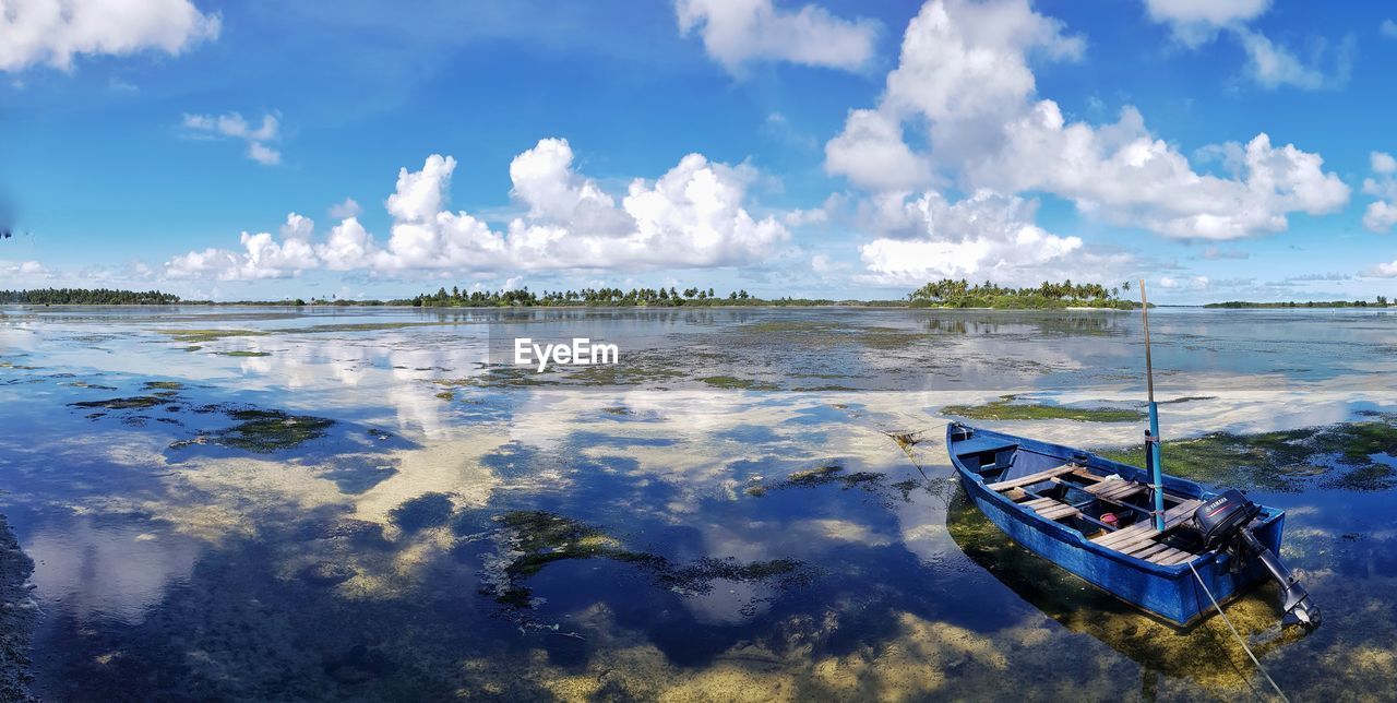 Panoramic view of boat moored in sea against sky