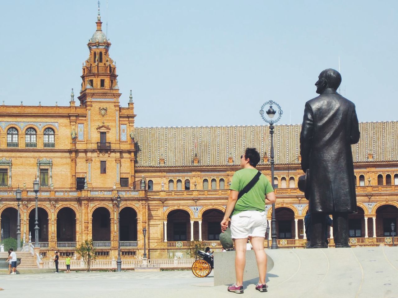 TOURISTS IN FRONT OF HISTORIC BUILDING