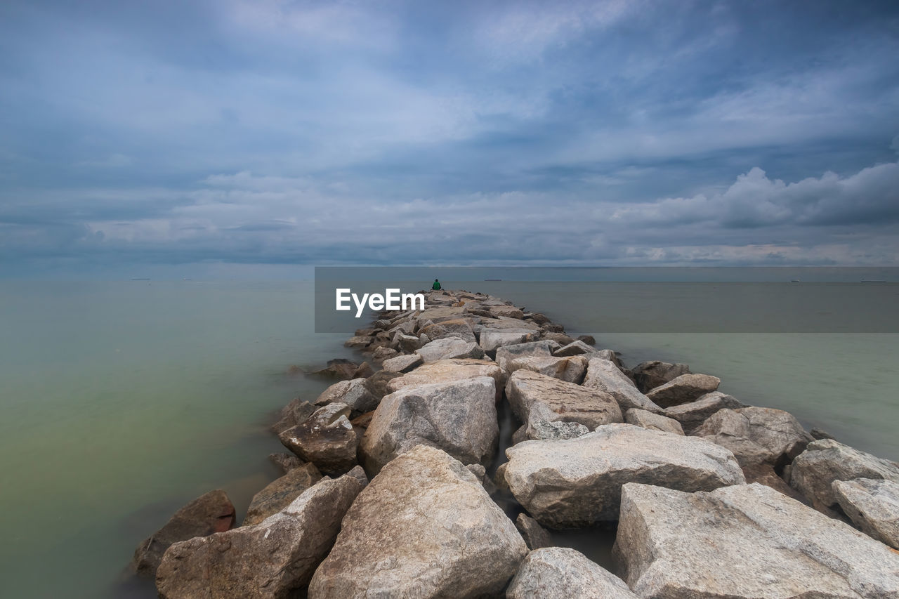 water, rock, sky, sea, cloud, coast, shore, land, nature, ocean, beach, scenics - nature, beauty in nature, tranquility, horizon, tranquil scene, no people, environment, horizon over water, terrain, outdoors, landscape, day, cliff, travel destinations, coastline, sand, body of water, travel, seascape, non-urban scene, wave, bay