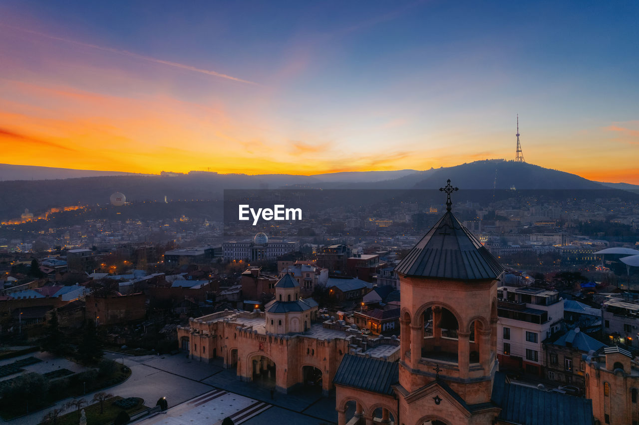 high angle view of illuminated buildings against sky during sunset