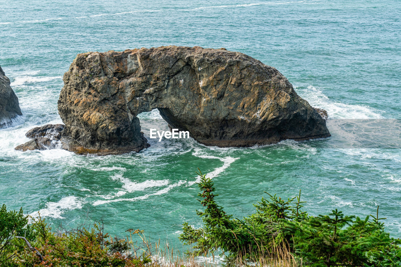 A view of an offshore land arch at arch rock state park in oregon state.