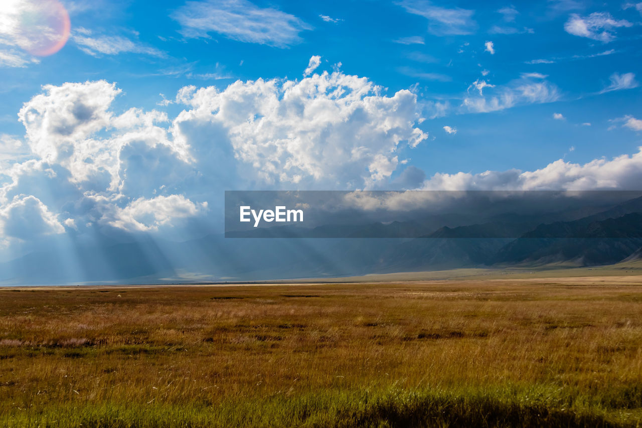 Scenic view of landscape against cloudy sky