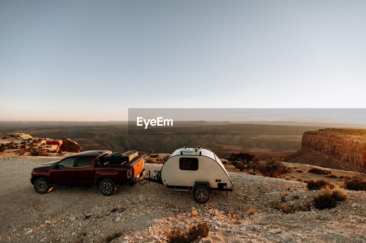 Teardrop camper rv and red pickup truck parked at desert view, utah