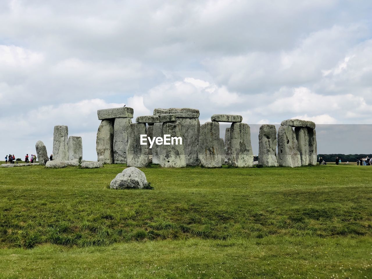 Built structure on field against cloudy sky