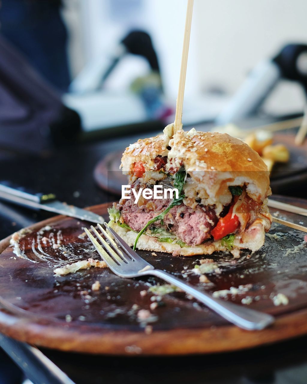 Close-up of burger with fork on table