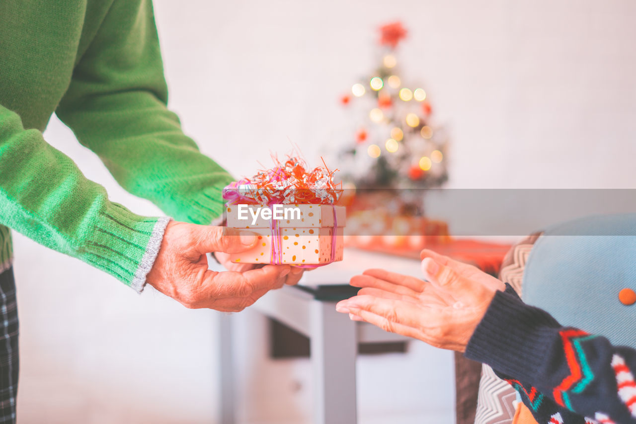 midsection of woman holding christmas decorations