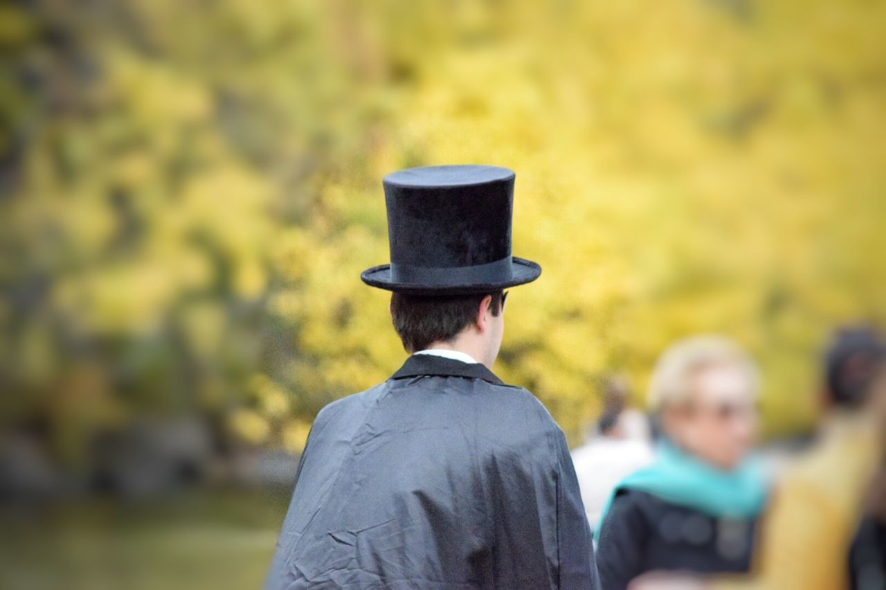 Rear view of man wearing hat at park during halloween