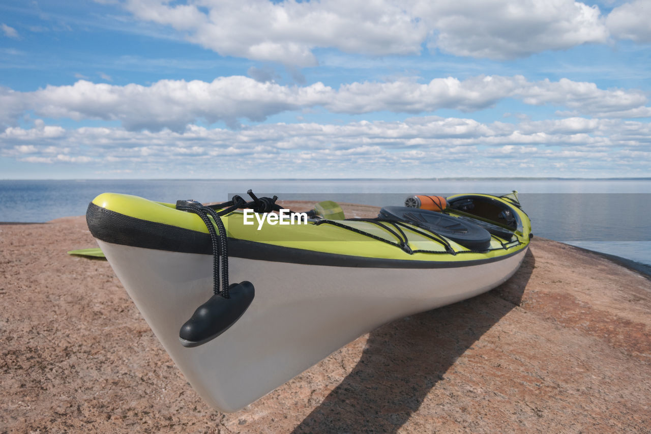 Sea kayak on the granite shore. bay in background