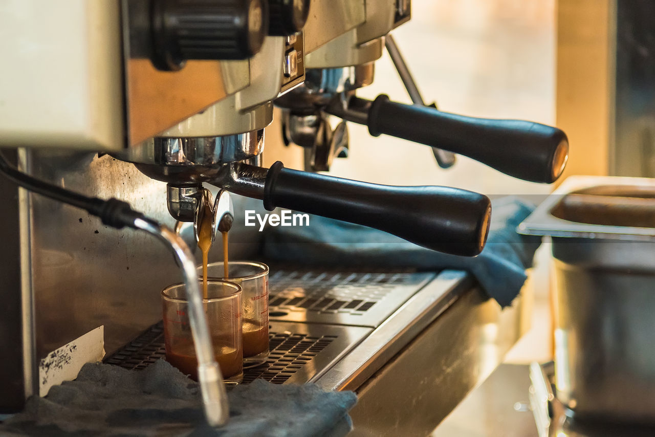 CLOSE-UP OF COFFEE AND MACHINE
