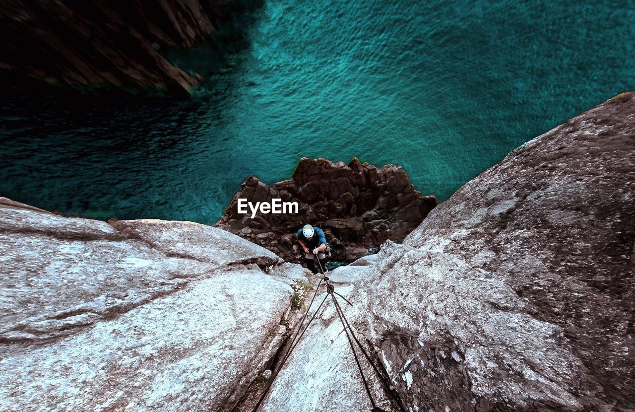 High angle view of man rock climbing