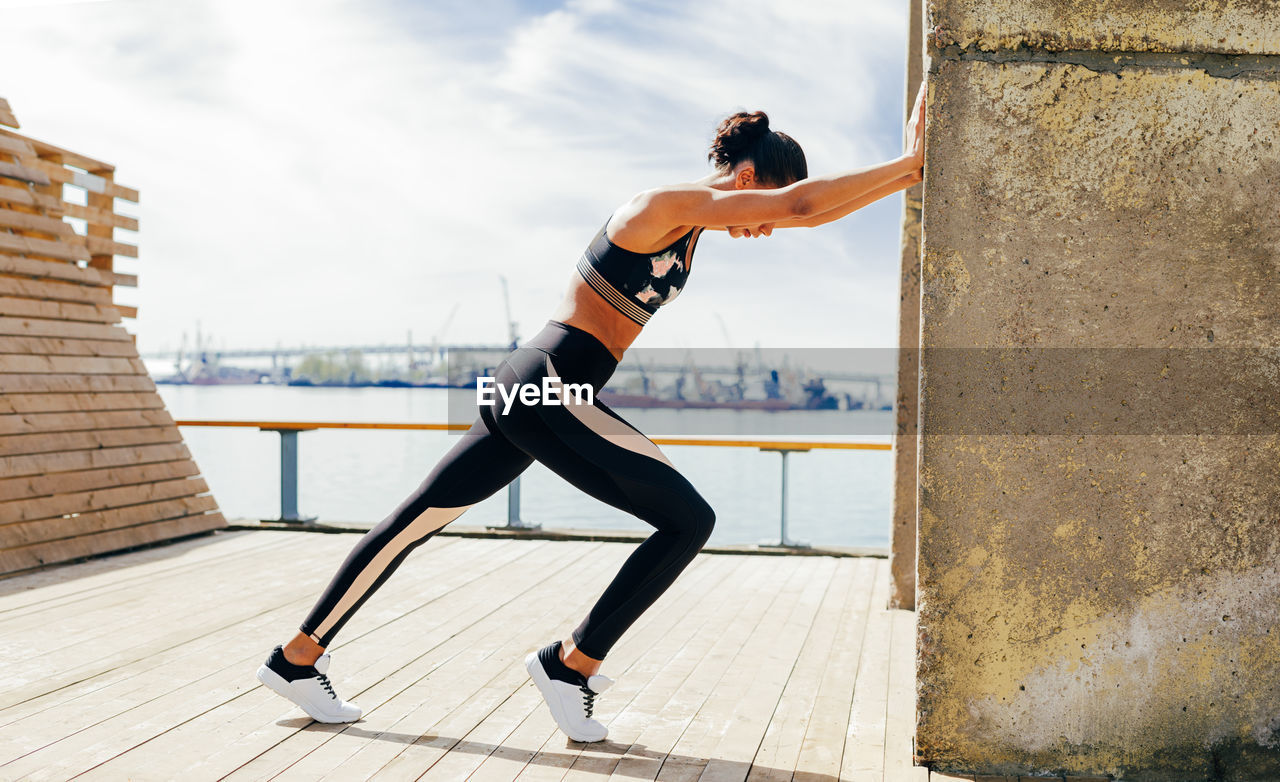 Female athlete leaning on wall