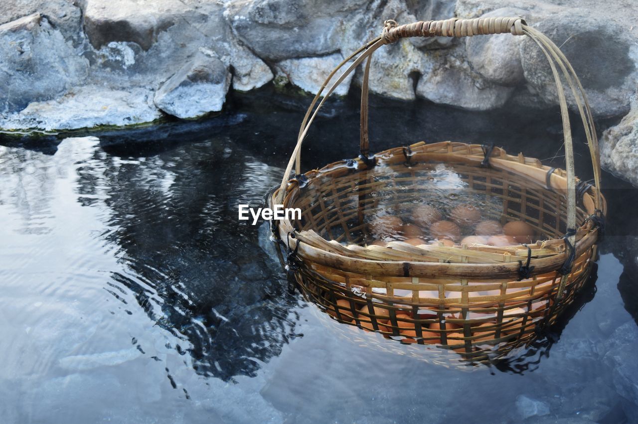 High angle view of eggs in water in basket