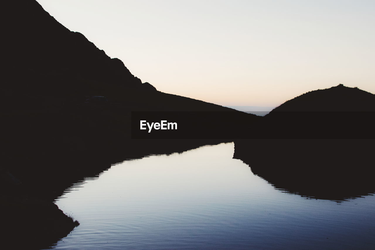 Scenic view of silhouette mountain against sky during sunset