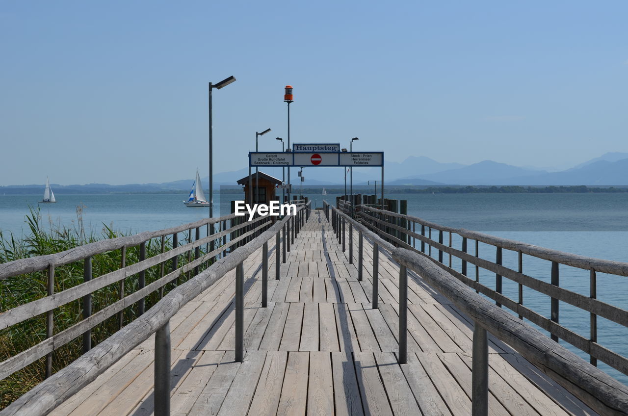 Pier over sea against clear sky