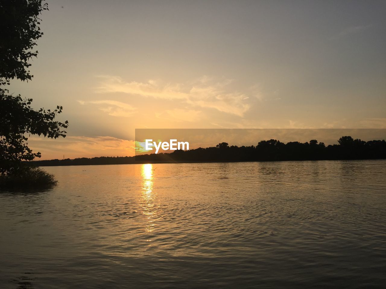 SCENIC VIEW OF SUNSET OVER WATER