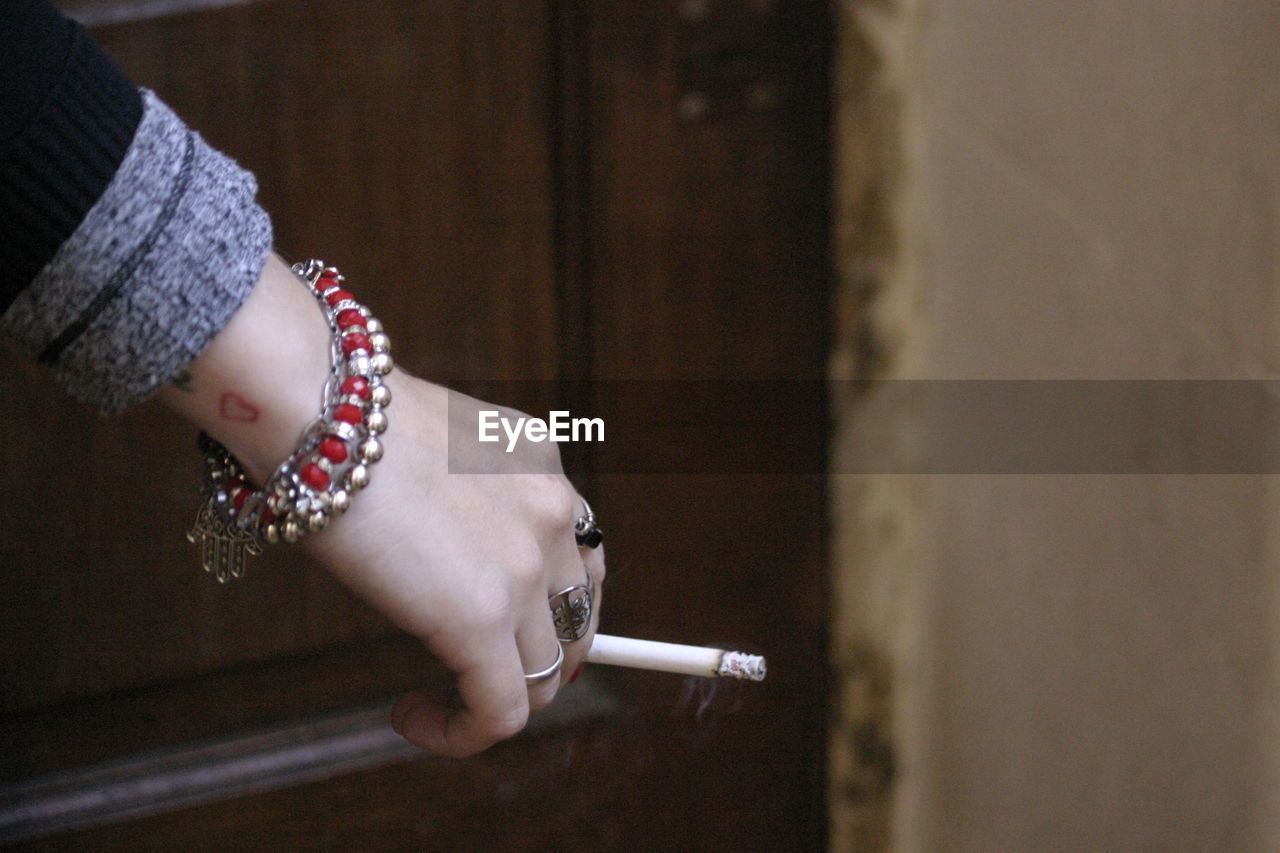 Cropped hand of woman holding cigarette