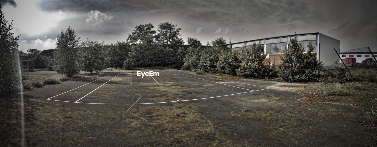 Empty field against cloudy sky