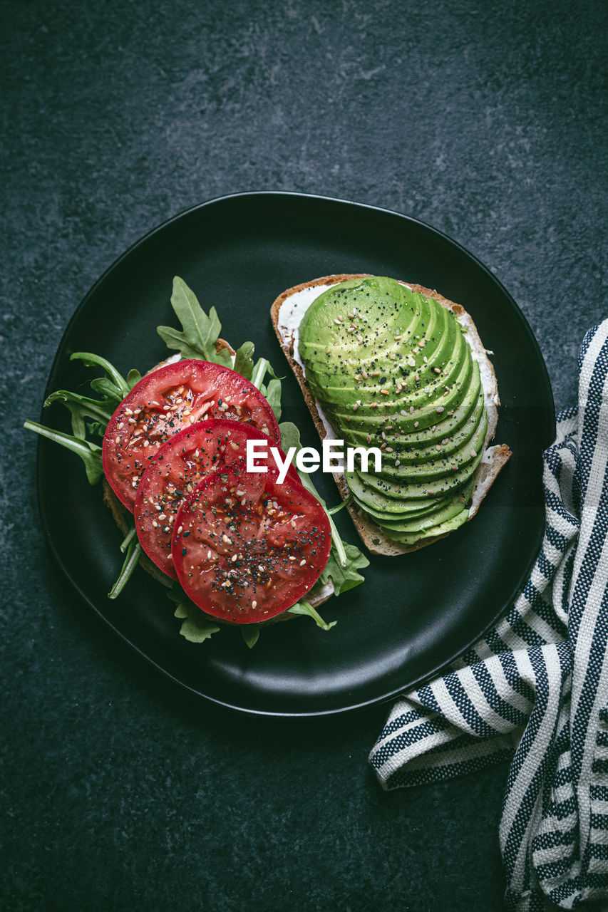 High angle view of avocado on toasted bread in plate