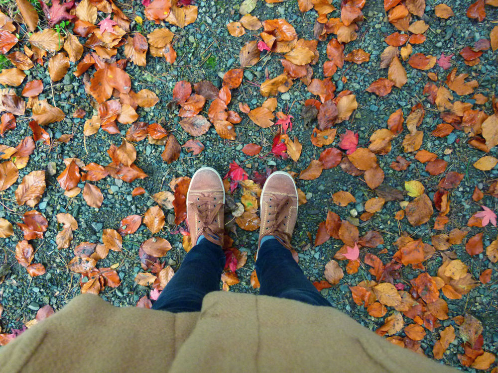 LOW SECTION OF WOMAN STANDING ON TILED FLOOR