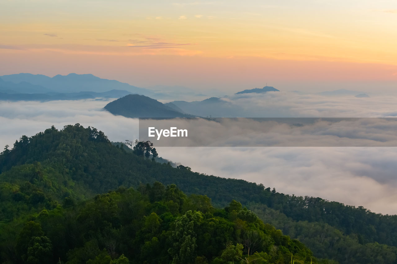 Scenic view of mountains against sky at sunset