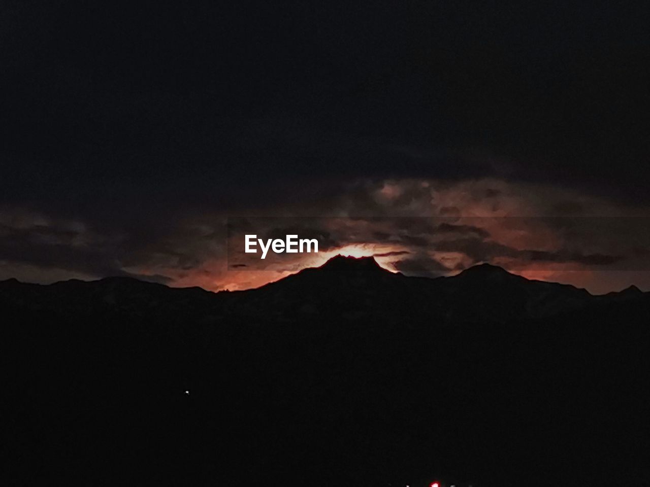 SILHOUETTE MOUNTAINS AGAINST SKY AT SUNSET