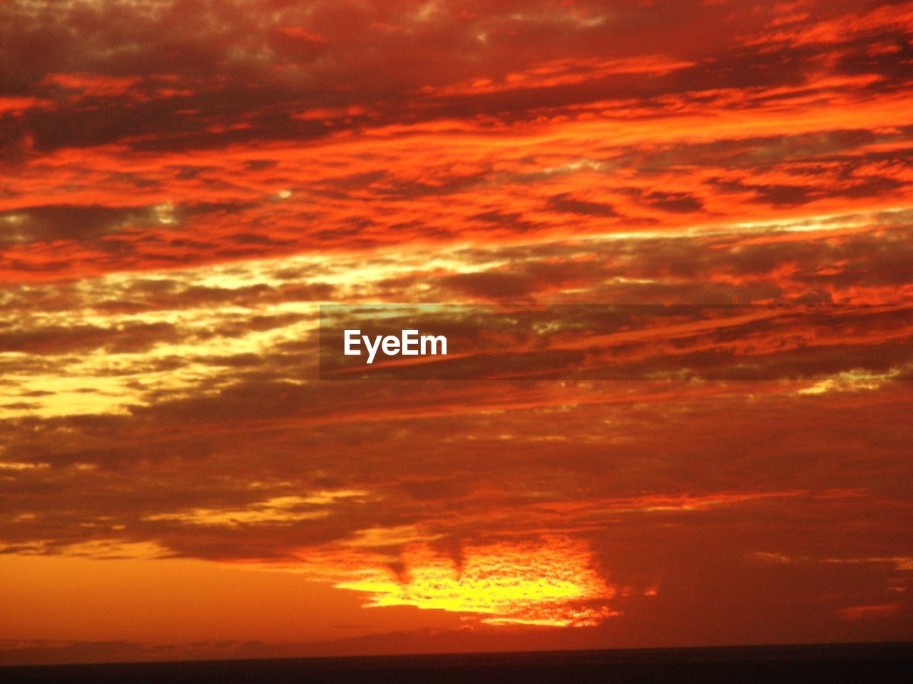 Scenic view of orange dramatic sky