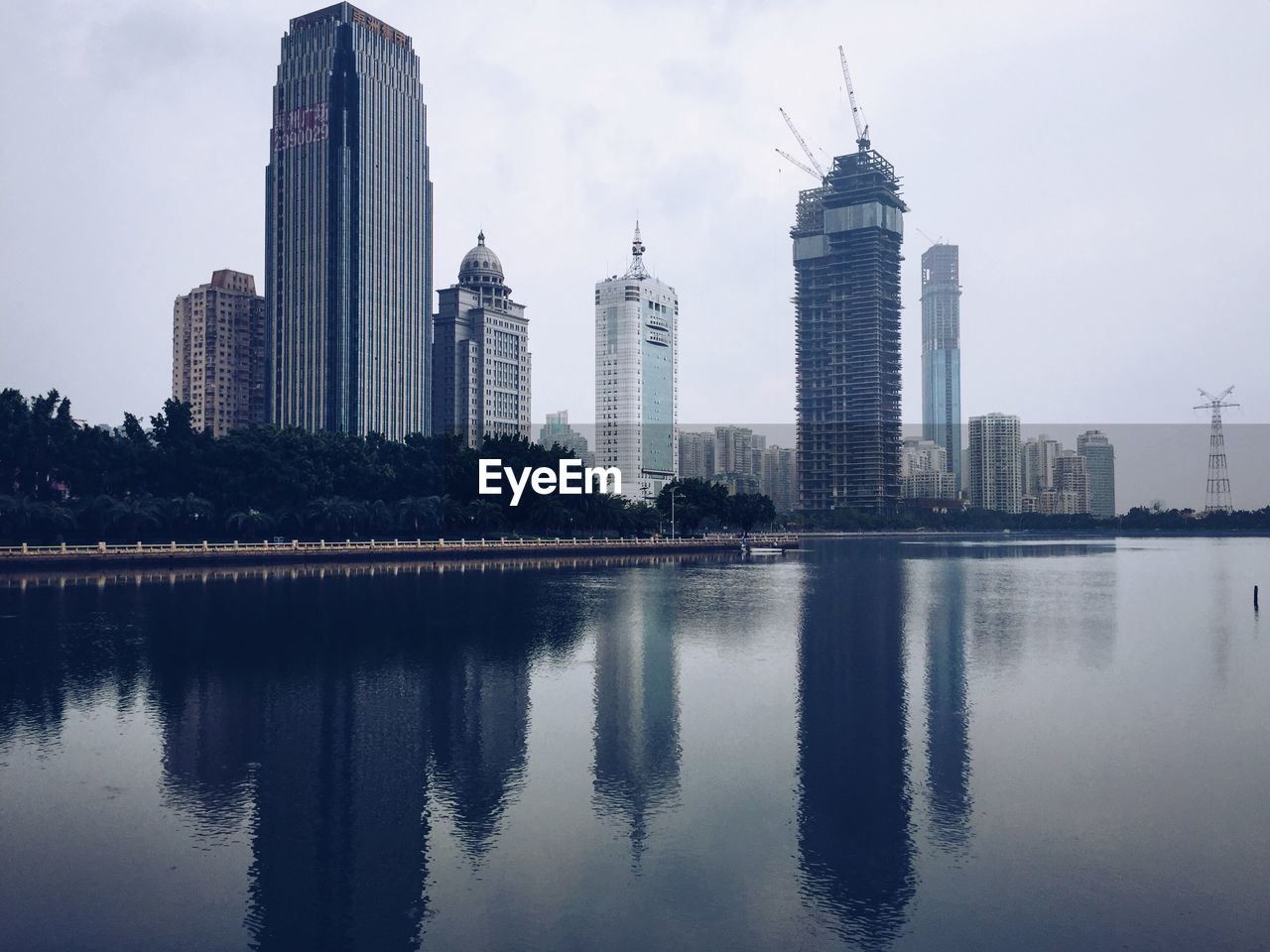 REFLECTION OF SKYSCRAPERS ON CALM RIVER