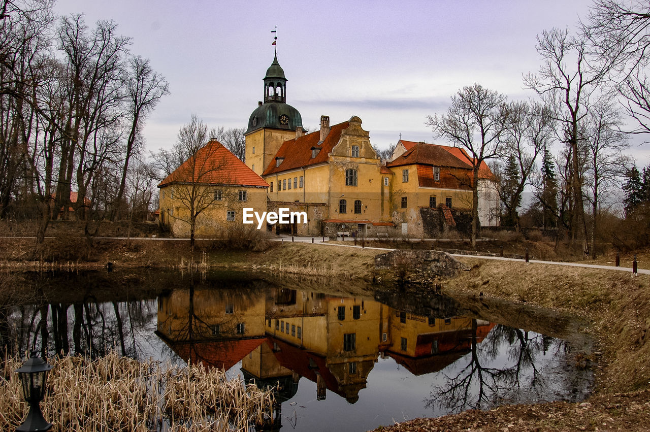 REFLECTION OF BUILT STRUCTURE IN PUDDLE