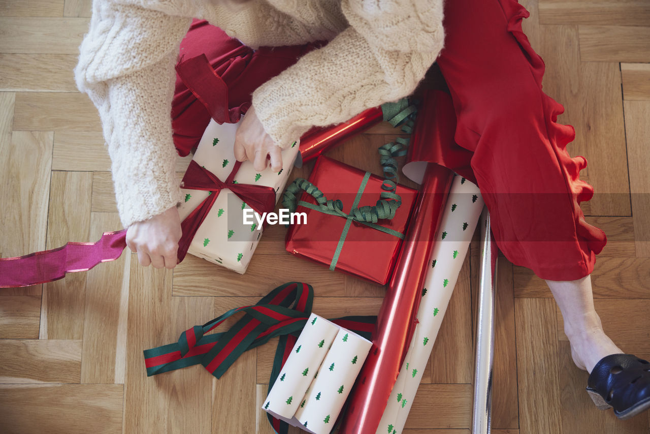 Woman's hands packing christmas presents