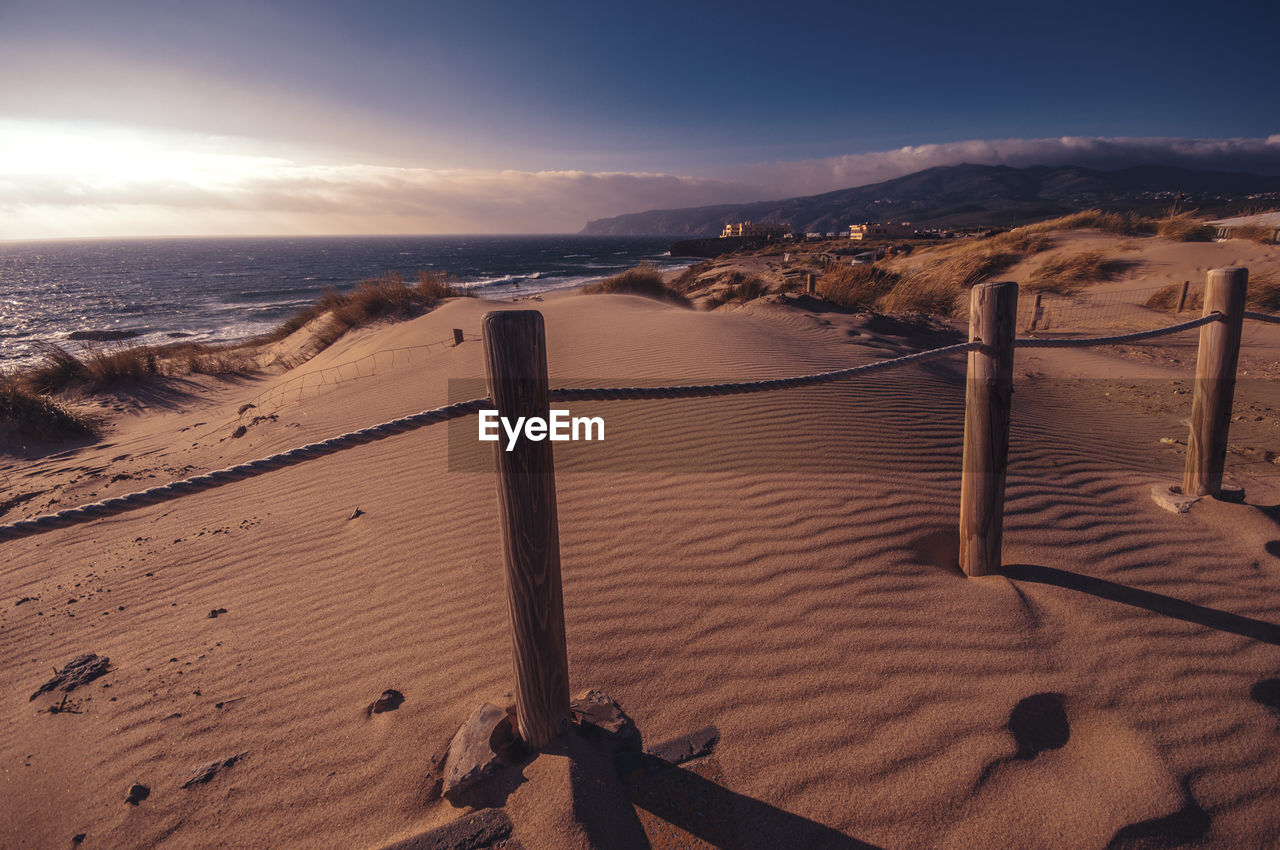 Scenic view of beach against sky during sunset