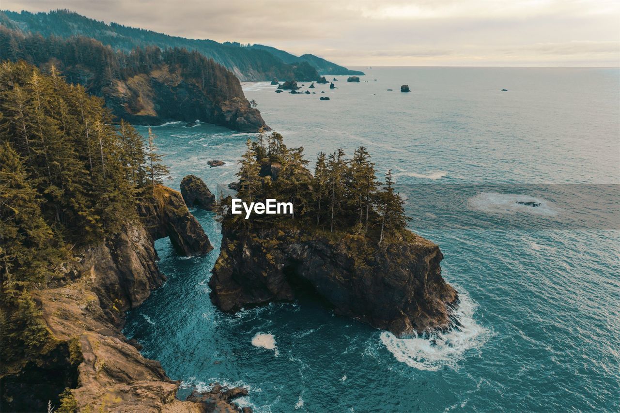 Scenic view of rocks in sea against sky