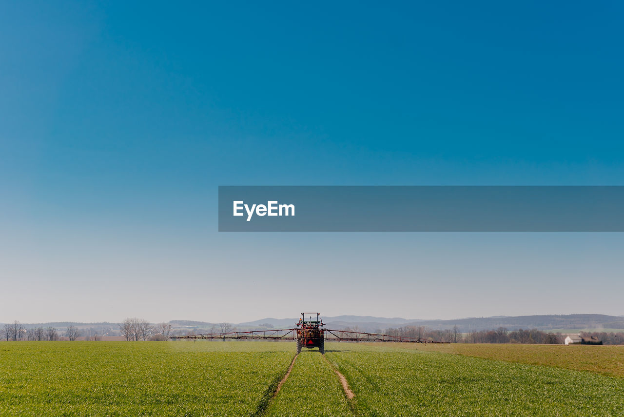 SCENIC VIEW OF AGRICULTURAL FIELD AGAINST CLEAR SKY