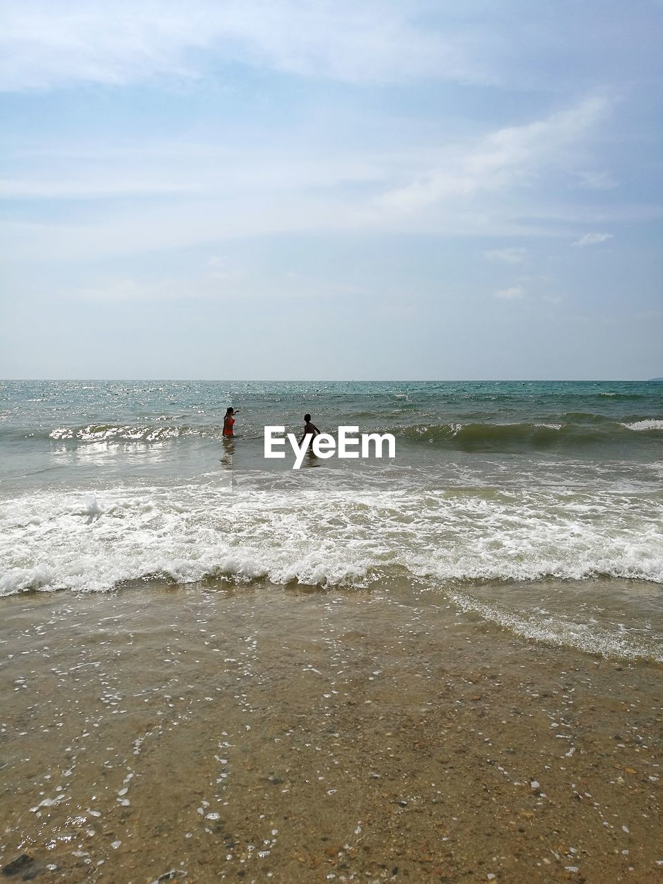 PEOPLE AT BEACH AGAINST SKY