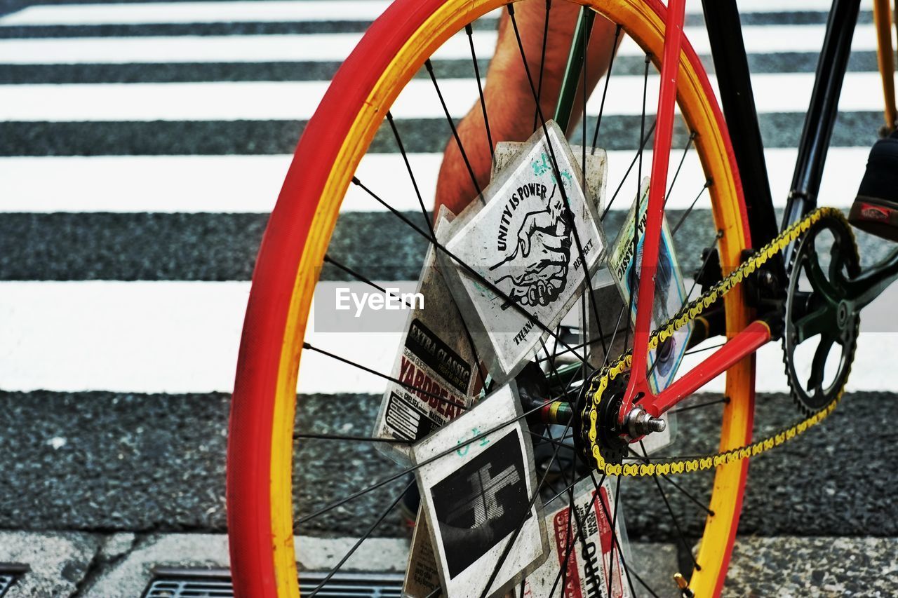 CLOSE-UP OF BICYCLE PARKED ON ROAD