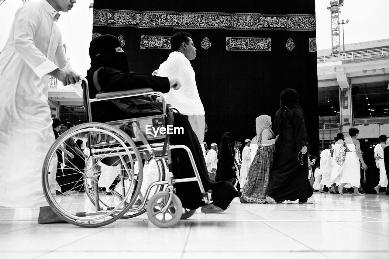 REAR VIEW OF MAN HOLDING LUGGAGE