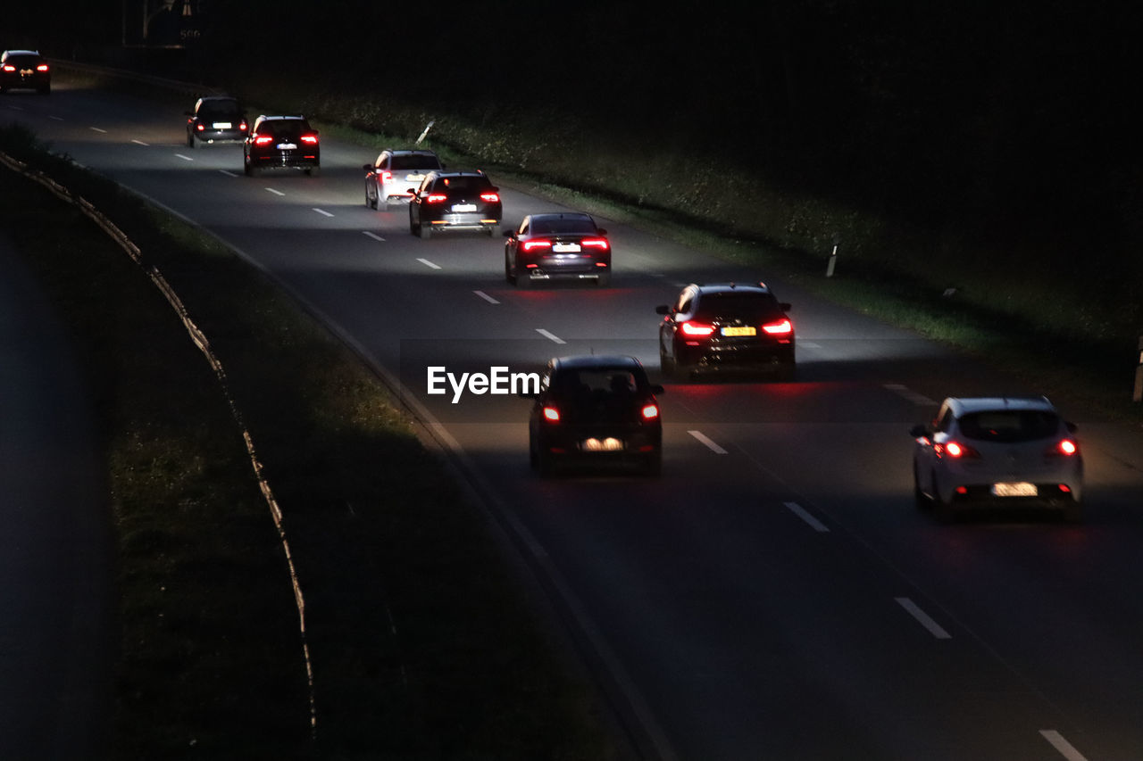 VEHICLES ON ROAD AT NIGHT