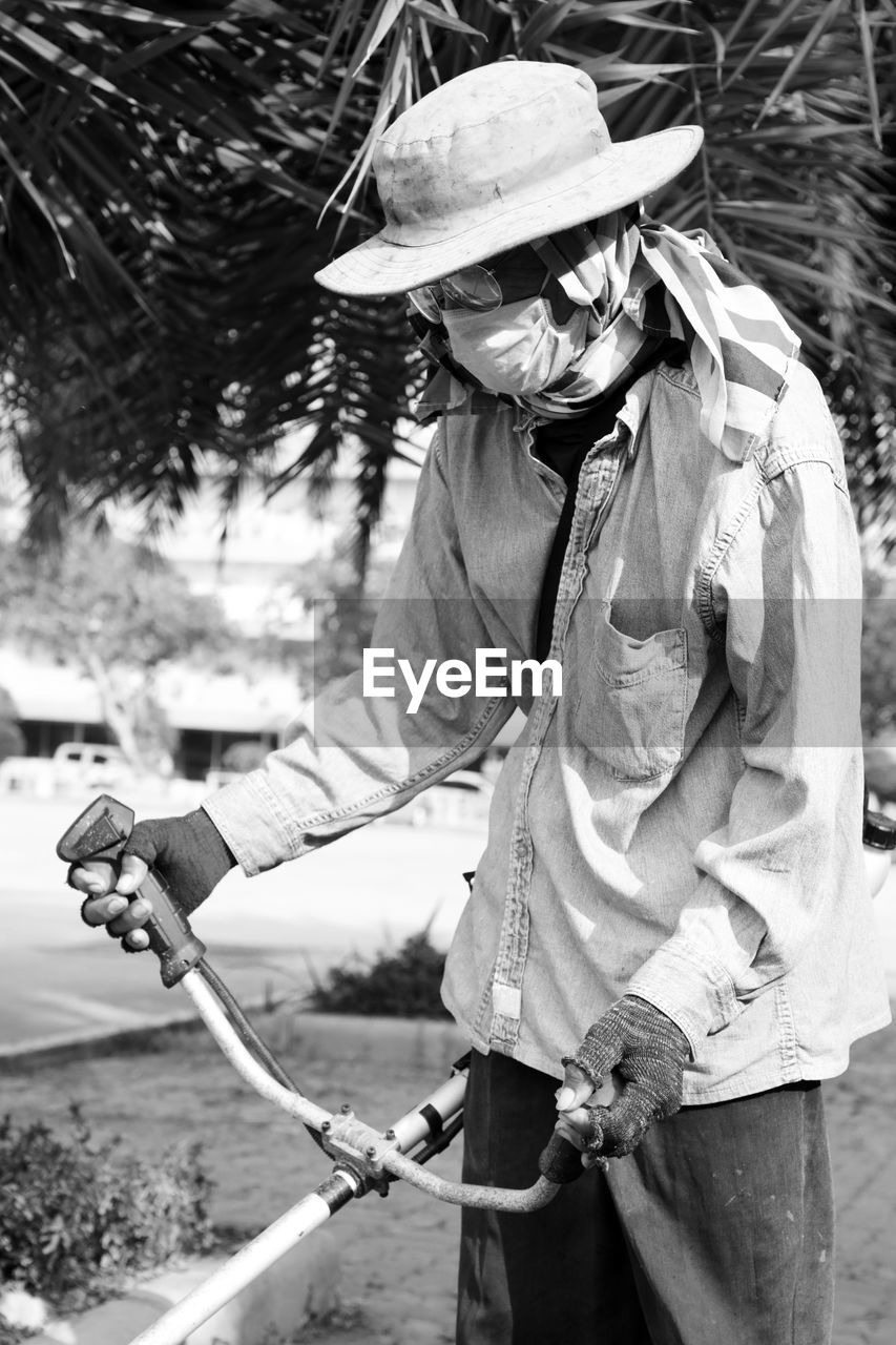 Senior man watering plants outdoors