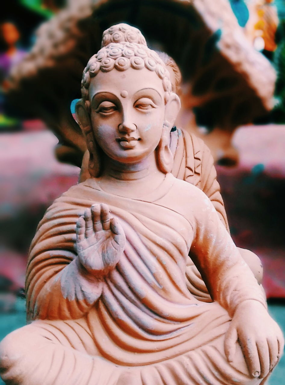 Close-up of buddha idol at workshop