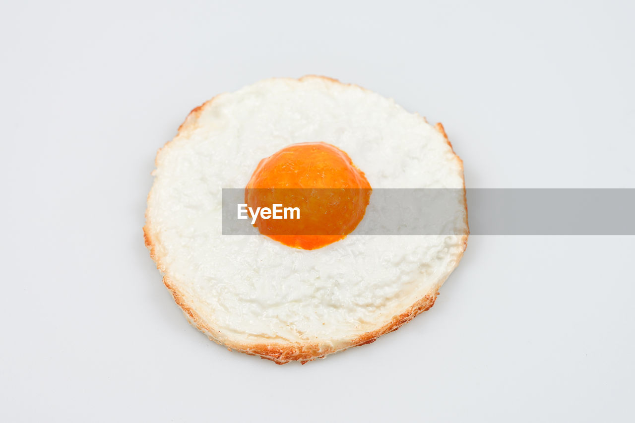 food, food and drink, egg, breakfast, healthy eating, freshness, white background, wellbeing, studio shot, fried egg, egg yolk, fried, indoors, produce, meal, dish, cut out, no people, bread, sunny side up, white, close-up, raw food, simplicity, circle, single object, geometric shape, directly above, dessert