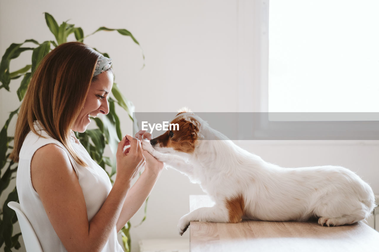 Side view of young woman with dog