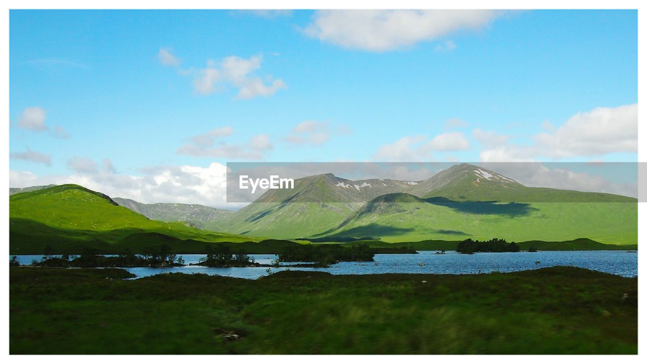 Scenic view of lake against cloudy sky