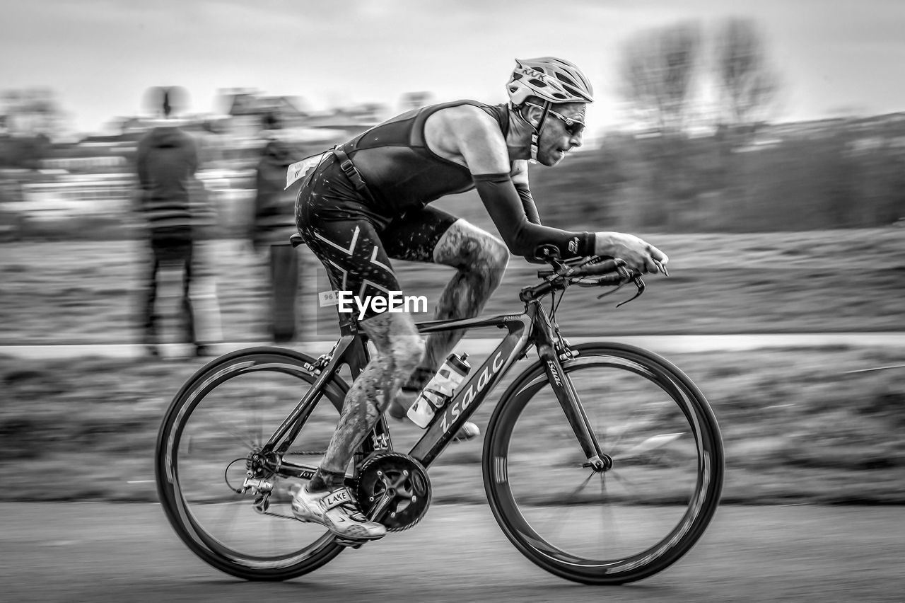 MAN RIDING BICYCLE ON A MOTORCYCLE